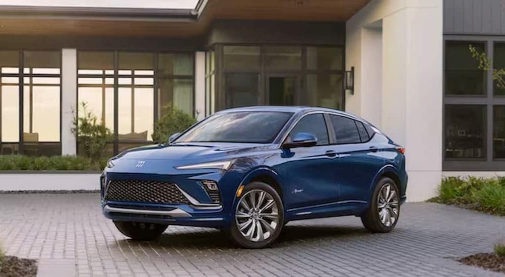A blue 2024 Bucick Envista Avenir is shown parked close to a Buick dealer near Brighton.