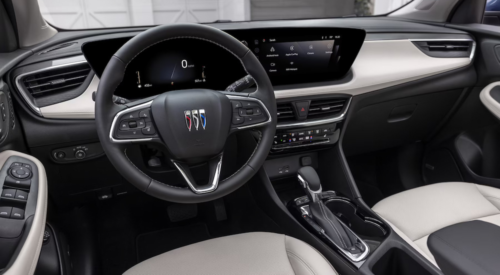 The steering wheel and dashboard of a 2024 Buick Encore GX Avenir at a Buick dealer near Clinton.