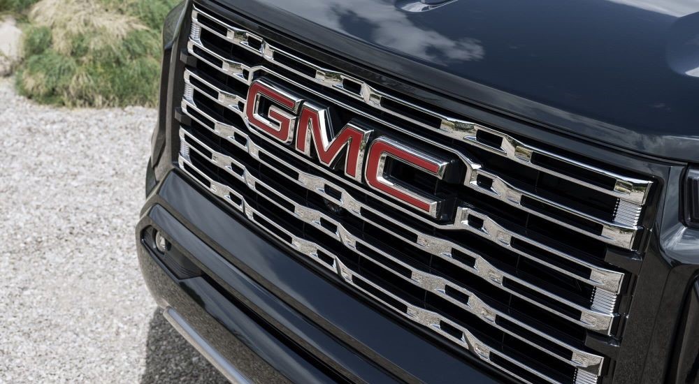 A close-up on the grille of a black 2024 GMC Canyon Denali.