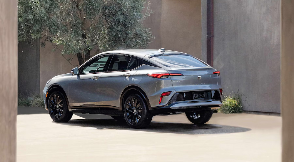 Rear view of a silver 2025 Buick Envista ST parked in a courtyard.