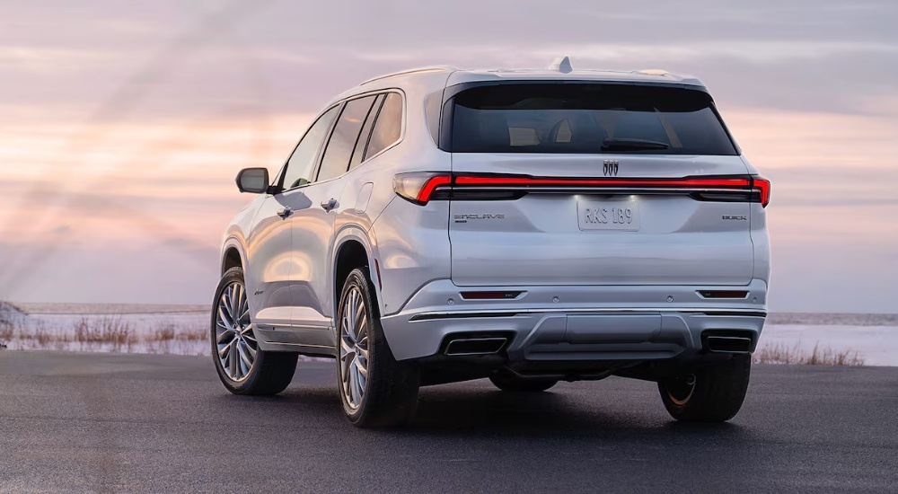 A white 2025 Buick Enclave is shown from the rear.