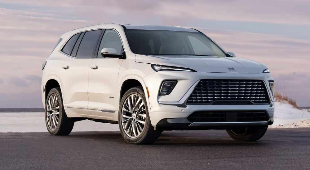 A white 2025 Buick Enclave is shown from the front at an angle.