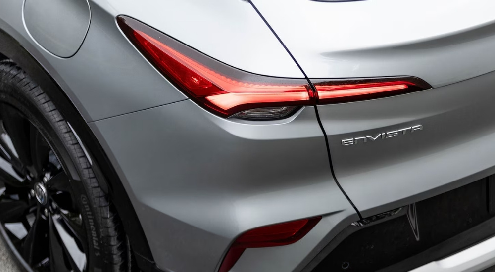 A close-up shows the driver side taillight on a grey 2025 Buick Envista.