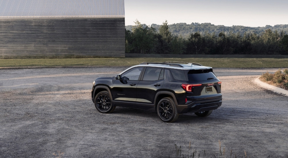 A black 2025 GMC Terrain from the rear.
