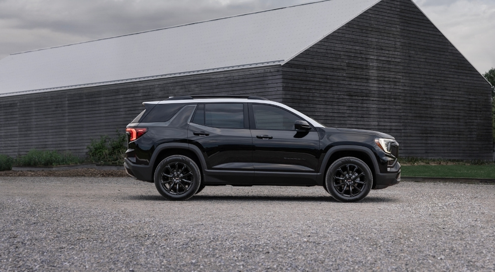 A black 2025 GMC Terrain from the side.