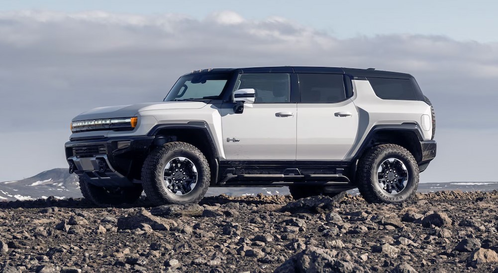 A white 2025 GMC Hummer EV parked off-road.
