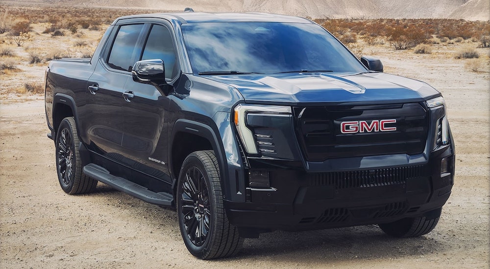 Black 2026 GMC Sierra EV Elevation parked in a desert.