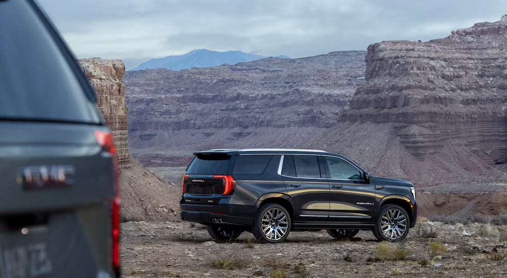 Black 2025 GMC Yukon Denali for sale parked in a desert.