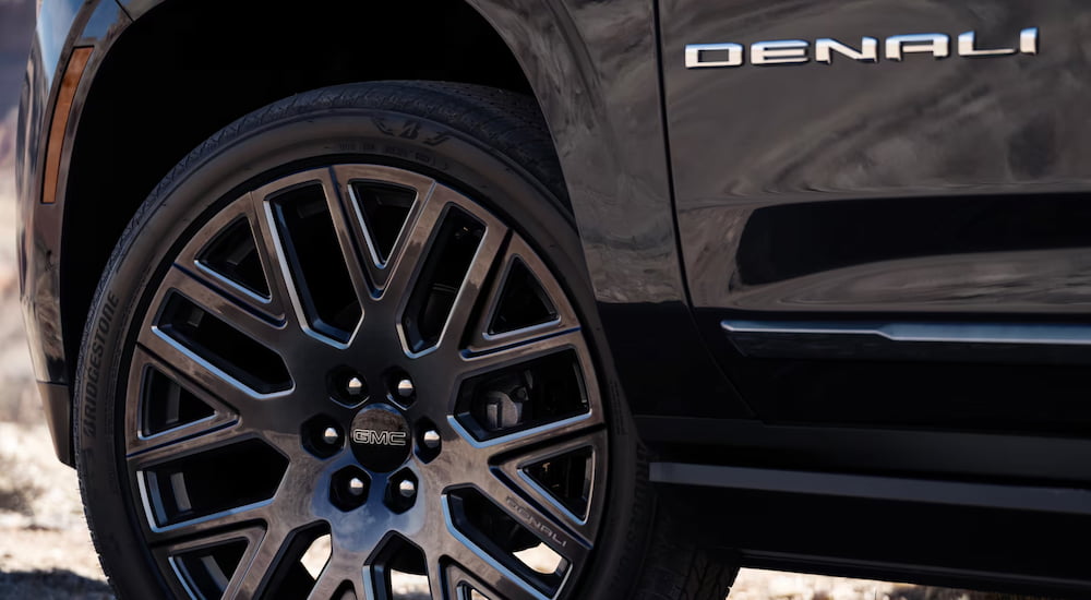 Close-up on the wheel of a black 2025 GMC Yukon Denali.