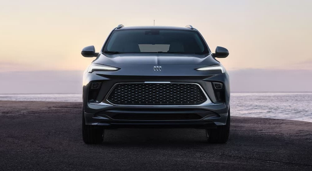 A blue 2026 Buick Encore GX parked on a beach.
