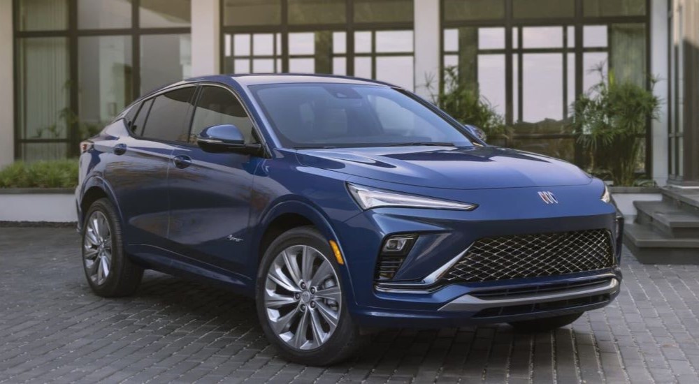 A blue 2024 Buick Envista Avenir shown parked in a driveway angled right.