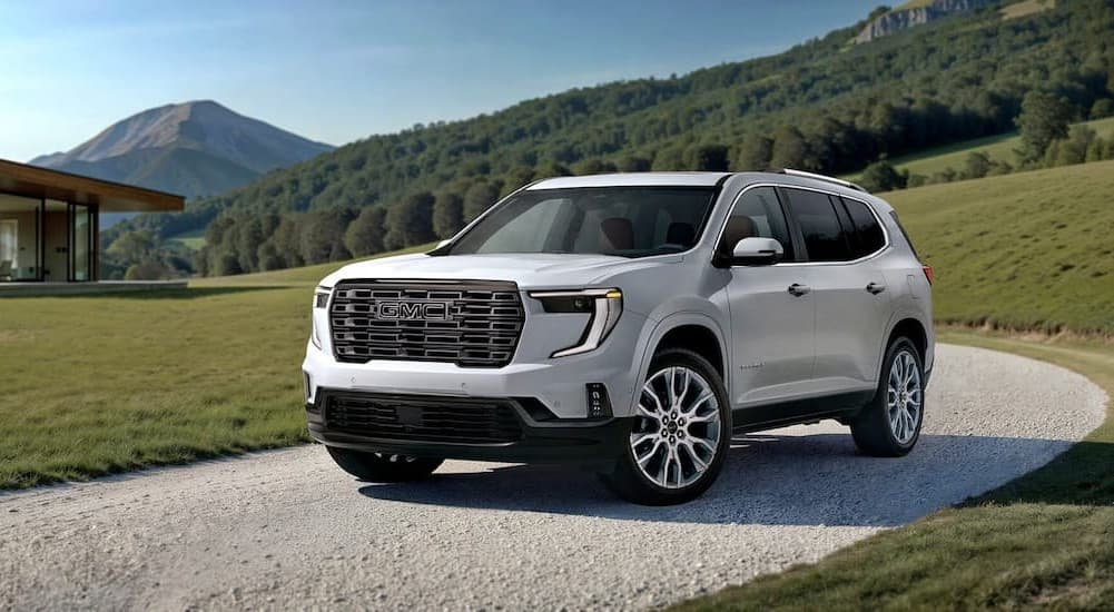 A white 2026 GMC Acadia parked on a driveway.