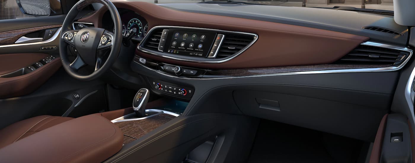The black and brown interior of a 2021 Buick Enclave Avenir.