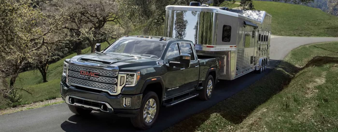 Grey 2023 GMC Sierra 2500 HD towing a horse trailer