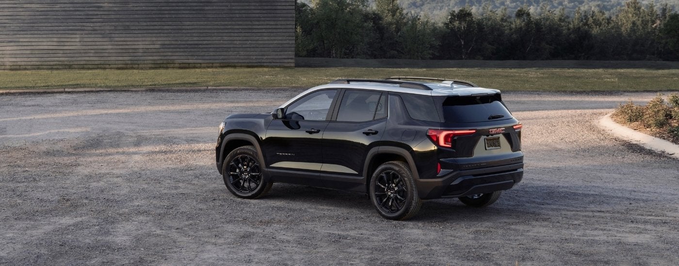 A black 2025 GMC Terrain from the side.