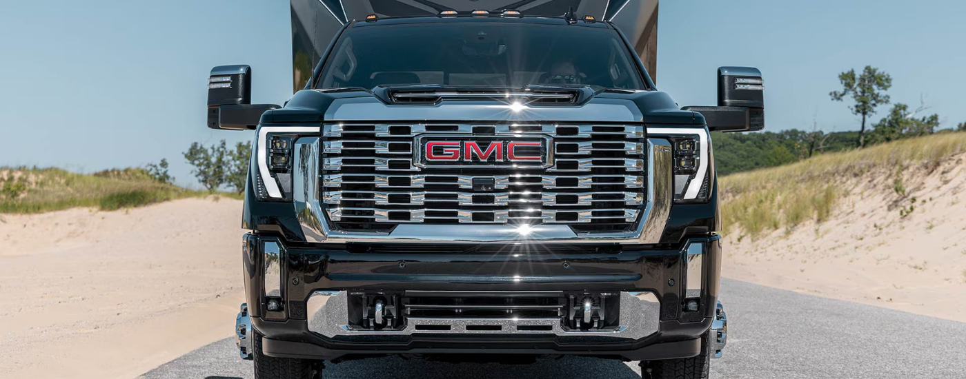Black 2026 GMC Sierra 2500 HD Denali with a RV hooked up