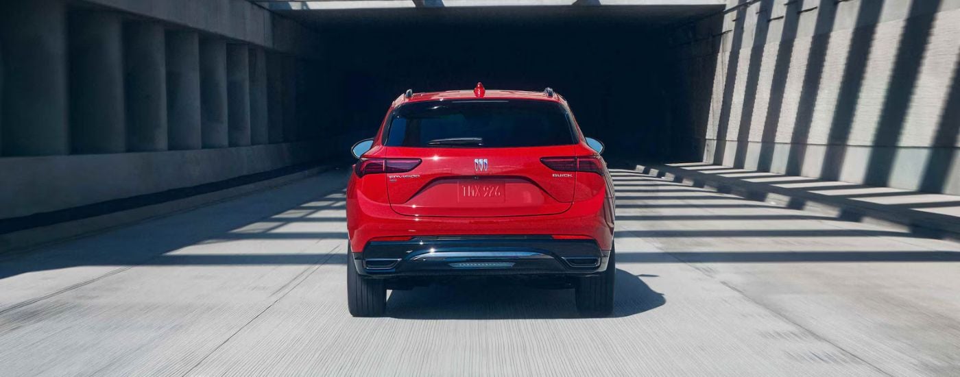 Rear view of a red 2026 Buick Envision on the freeway.