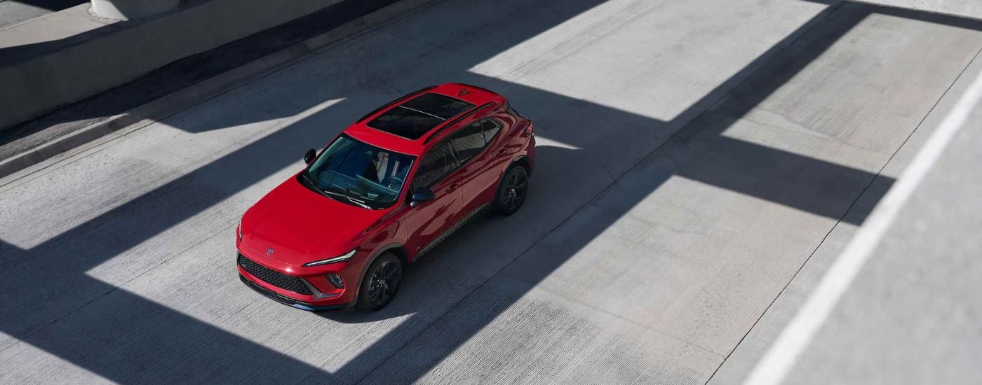 A red 2026 Buick Envision shown from above and parked in a covered lot.