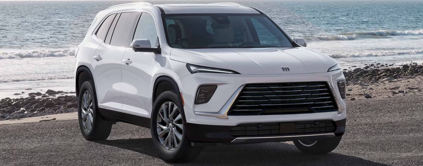 A white 2026 Buick Enclave parked on a beach.