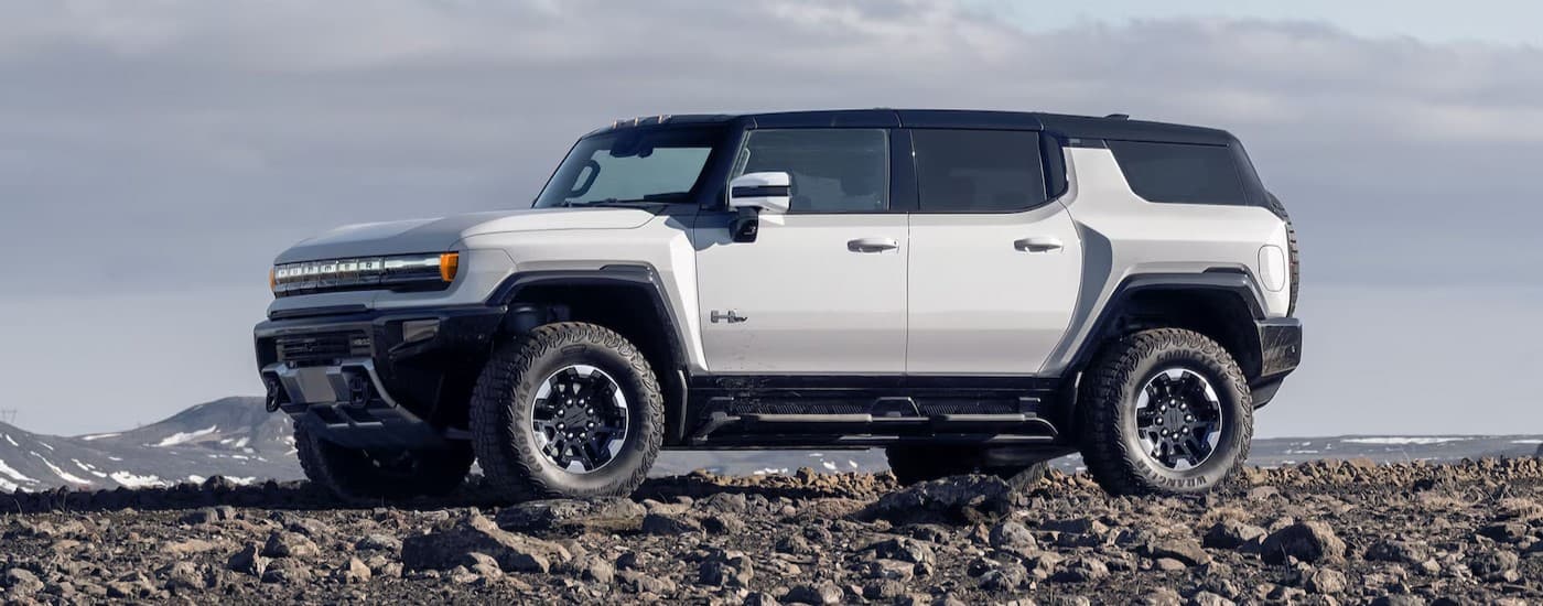 A white 2025 GMC Hummer EV parked off-road.