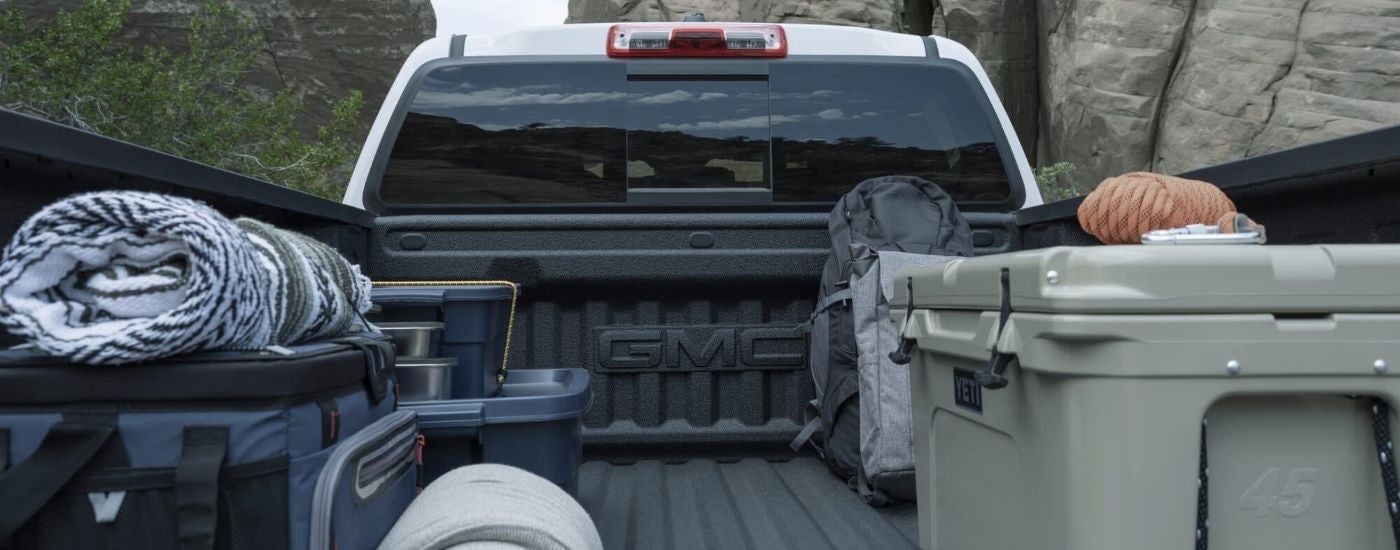 A view of supplies in the bed of a white 2024 GMC Canyon AT4.