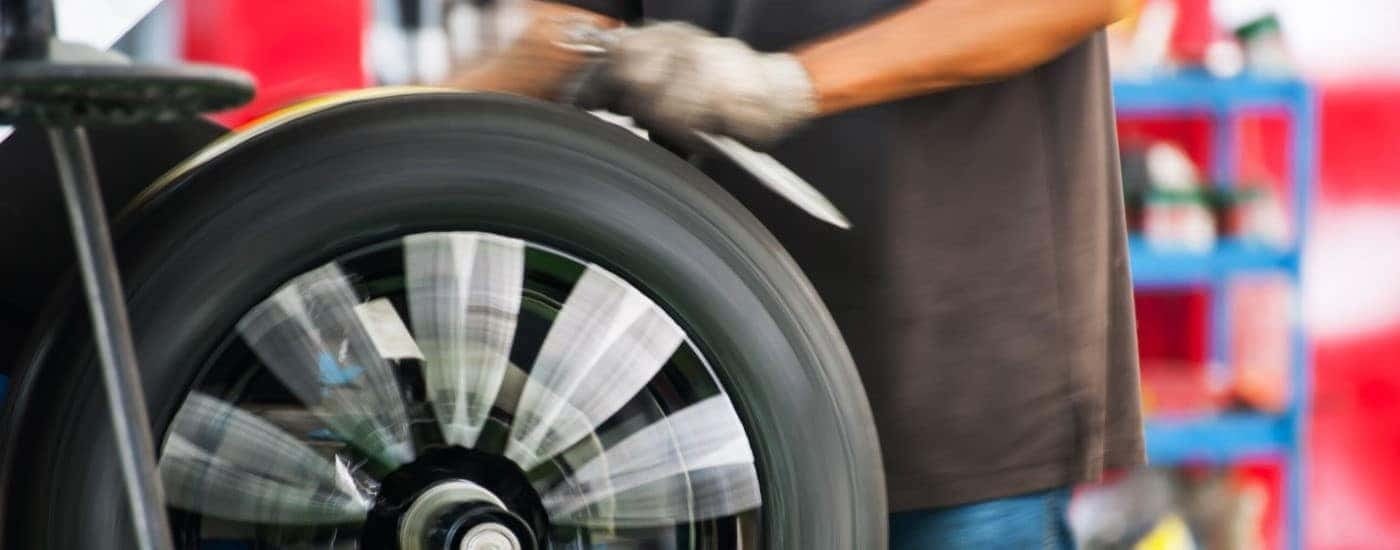 Mechanic balancing a tire in a shop