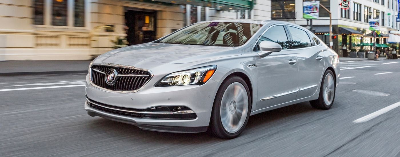 A white 2019 Buick LaCrosse driving on a city street.