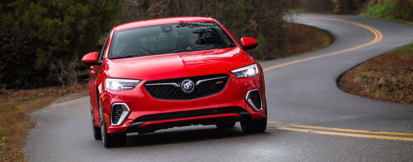 A red 2019 Buick Regal GS driving down a winding road.